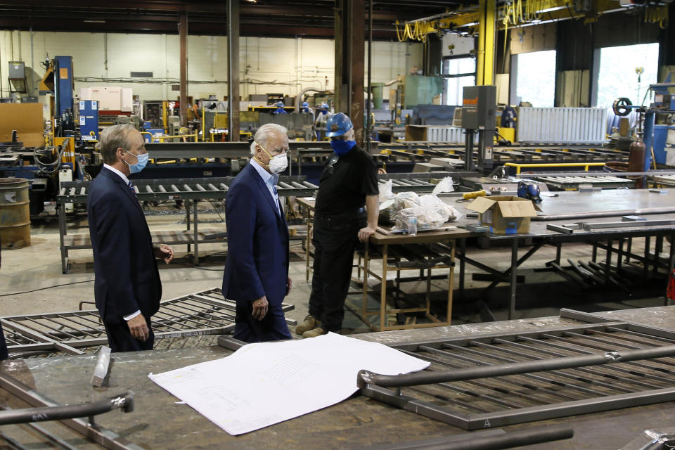 Democratic presidential candidate, former Vice President Joe Biden, center, and McGregor Industries owner Bob McGregor take a tour of the metal fabricating facility, Thursday, July 9, 2020, in Dunmore, Pa. (AP Photo/Matt Slocum)