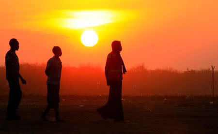 File Photo: People who fled fighting in South Sudan are seen walking at sunset on arrival at Bidi Bidi refugee resettlement camp near the border with South Sudan, in Yumbe district, northern Uganda December 7, 2016. REUTERS/James Akena/File Photo