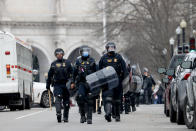 WASHINGTON, DC - JANUARY 06: Police officers in riot gear walks towards the U.S. Capitol as protesters enter the building on January 06, 2021 in Washington, DC. Trump supporters gathered in the nation's capital today to protest the ratification of President-elect Joe Biden's Electoral College victory over President Trump in the 2020 election. (Photo by Tasos Katopodis/Getty Images)