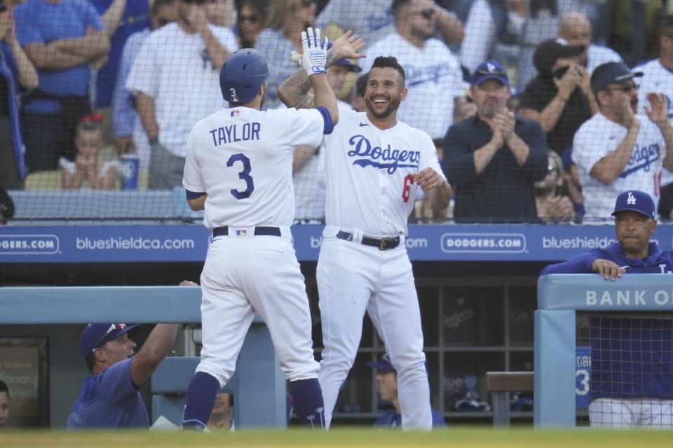 The Dodgers' Chris Taylor celebrates with David Peralta after scoring on Miguel Vargas ' seventh-inning triple June 3, 2023.