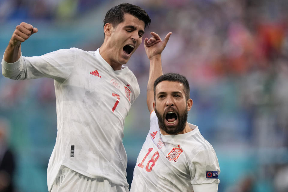 Spain's Jordi Alba celebrates with Alvaro Morata, left, after scoring the opening goal during the Euro 2020 soccer championship quarterfinal match between Switzerland and Spain at Saint Petersburg stadium in St. Petersburg, Russia, Friday, July 2, 2021. (AP Photo/Dmitri Lovetsky, Pool)