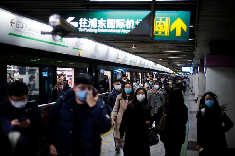 People wearing face masks are seen at a subway station following the coronavirus disease (COVID-19) outbreak, in Shanghai