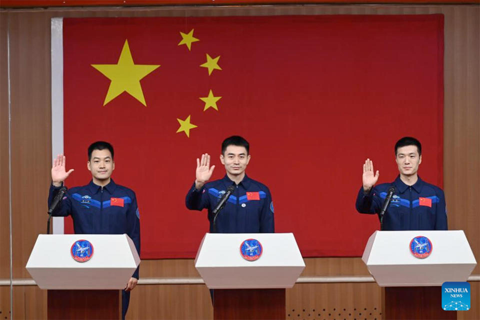 The Shenzhou 18 crew greeting journalists at a pre-launch news conference Wednesday. Left to right: Li Cong, commander Ye Guangfu and Li Guangsu. Guangfu is a space veteran, logging 182 days in orbit during a stay aboard the Tiangong space station in 2021-22. His two crewmates are making their first flight. / Credit: China Manned Space Agency