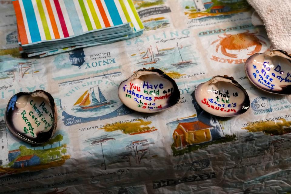 Tables are set up and decorated ahead of a meeting of the legislative commission looking for answers about the state's declining quahog harvests.