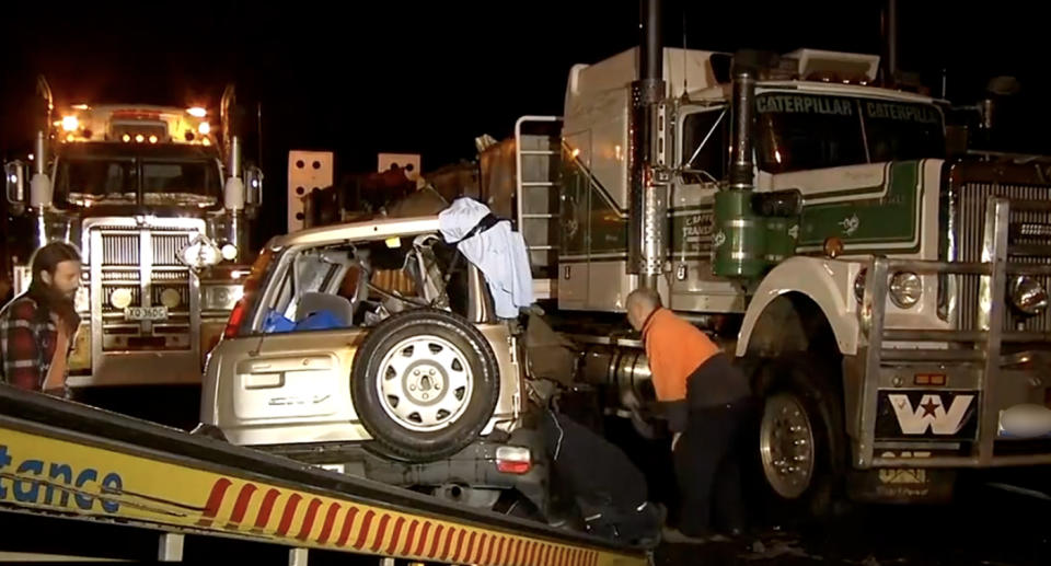 The totalled car at the crash scene. 