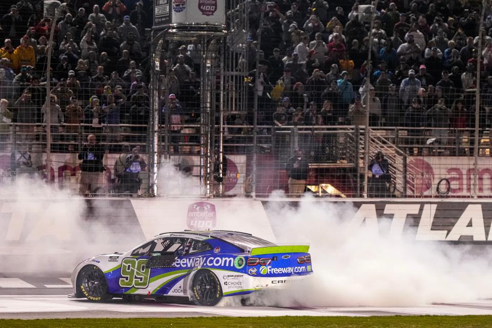 Feb 25, 2024; Hampton, Georgia, USA; NASCAR Cup Series driver Daniel Suarez (99) celebrates after winning the Ambetter Health 400 at Atlanta Motor Speedway. Mandatory Credit: David Yeazell-USA TODAY Sports