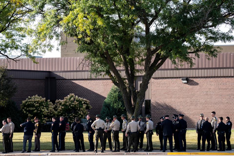 Uniformed officers line up outside the funeral for Algona Police Department Officer Kevin Cram at the Algona Community School on Wednesday, September 20, 2023 in Algona.