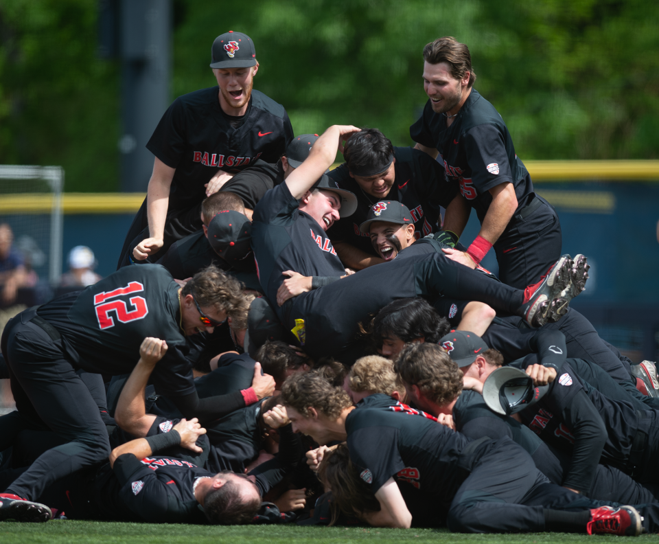 Ball State dog piles on the pitcher's mound after taking the win 12-9.