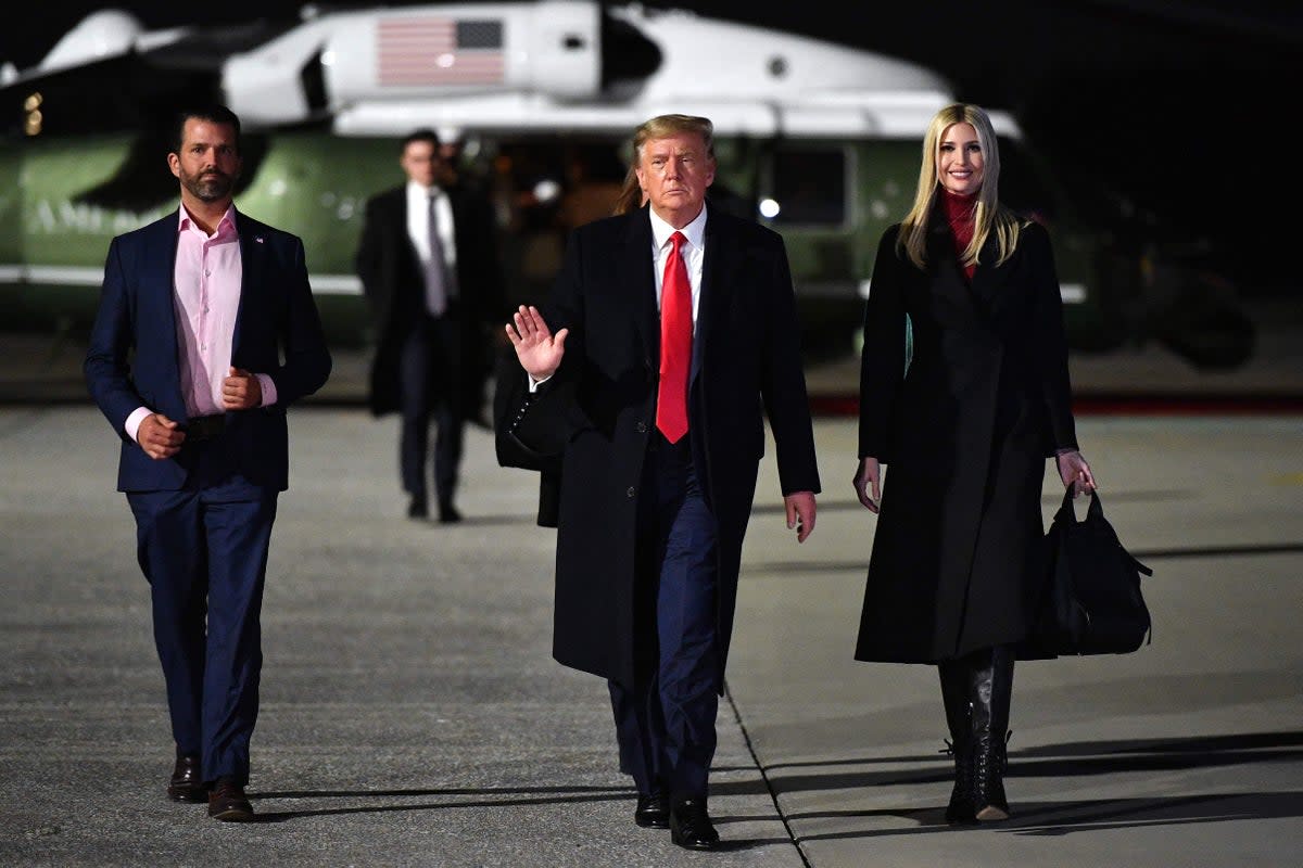 Ivanka Trump, right,  boards Air Force One with her father Donald Trump and her older brother Donald Trump Jr, right, in January 2021 (AFP via Getty Images)
