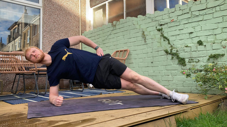 Fit & Well fitness writer Harry Bullmore performing a side plank