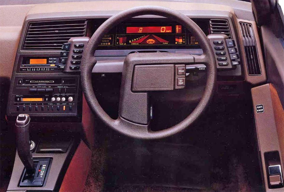 <p>The XT was the turbocharged wedge that time forgot. Its dashboard may have been created with cheap plastic, but what made it so glorious was its switch gear, digital display and three-spoke steering wheel. Mounting switches to the dashboard simply wasn’t good enough for Subaru, so the XT received two wing-like control units that were placed just behind the steering wheel. When switched on, the 3D display was oddly mesmerising with its <strong>backlit orange and red colour combination</strong>.</p>