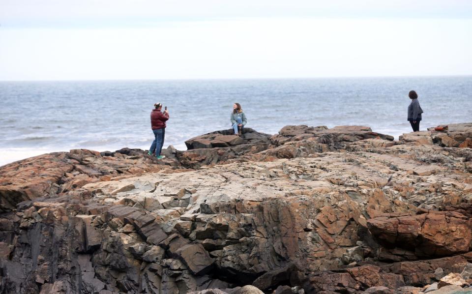 Visitors enjoy the views of the Atlantic Ocean along Marginal Way in Ogunquit. The scenic path reopened to the public after being closed for more than a month due to storm damage that eroded parts of the pavement and displaced rocks.