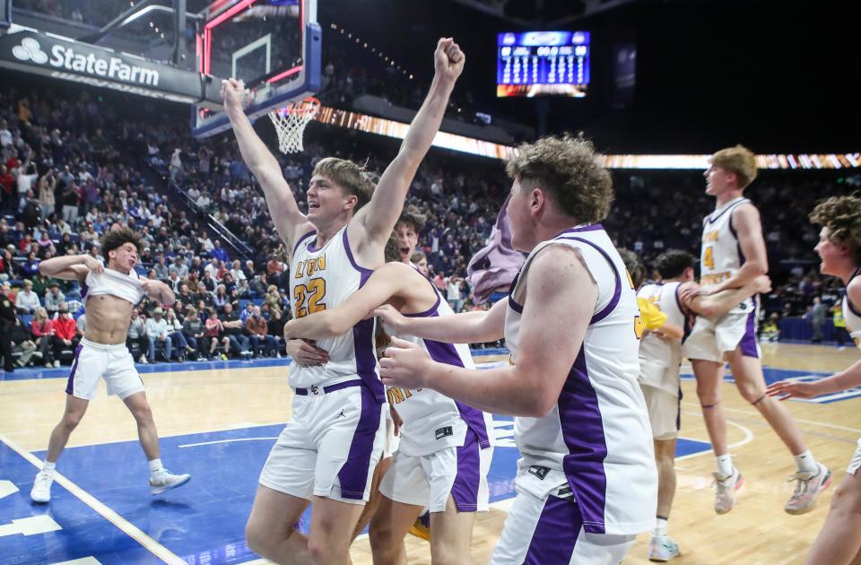 Lyon County's Brady Shoulders holds up his arms in celebration after the Lyons won the state title.