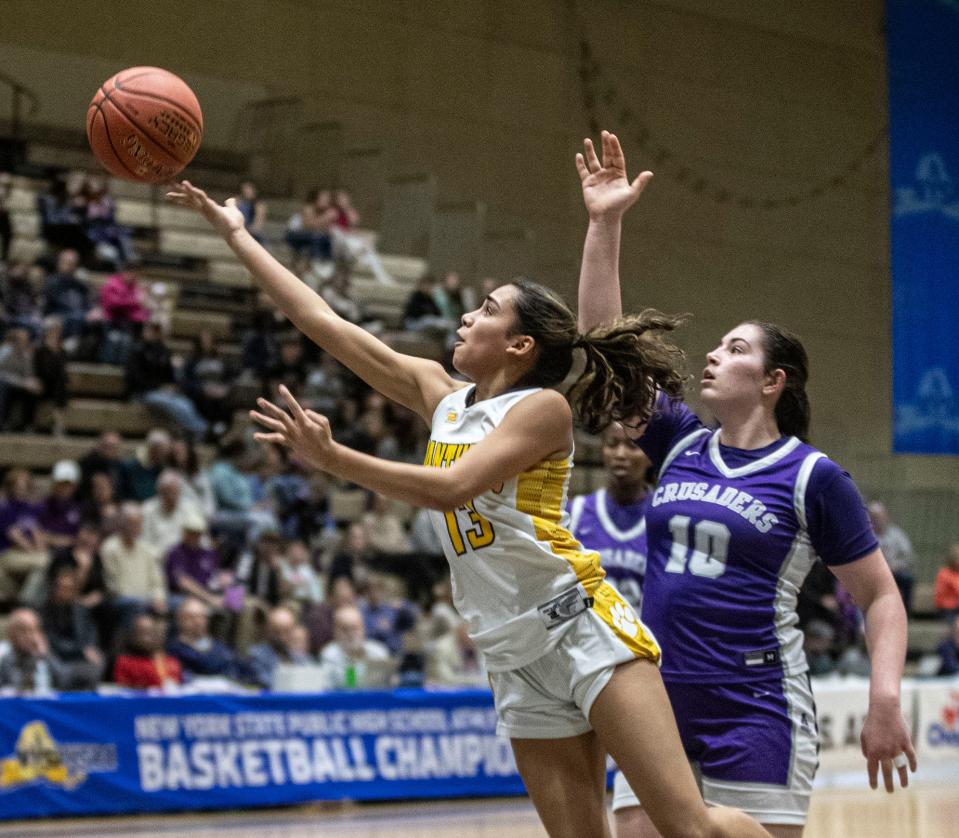 Sofia Tavarez of Walter Panas drives past Kristen Finn of Catholic Central during the New York State girls Class A basketball championship at Hudson Valley Community College in Troy March 16, 2024. Catholic Central defeated Walter Panas 64-62.