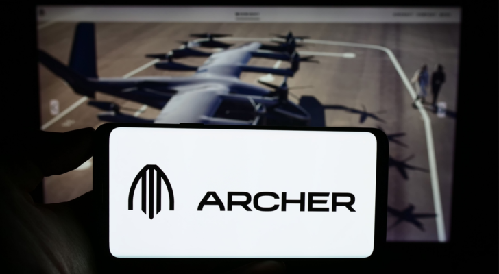 Person holding cellphone with logo of American eVTOL aircraft company Archer Aviation Inc. (ACHR) on screen in front of webpage. Focus on phone display. Unmodified photo.