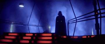 Darth Vader stands ominously on a bridge in a scene from Star Wars
