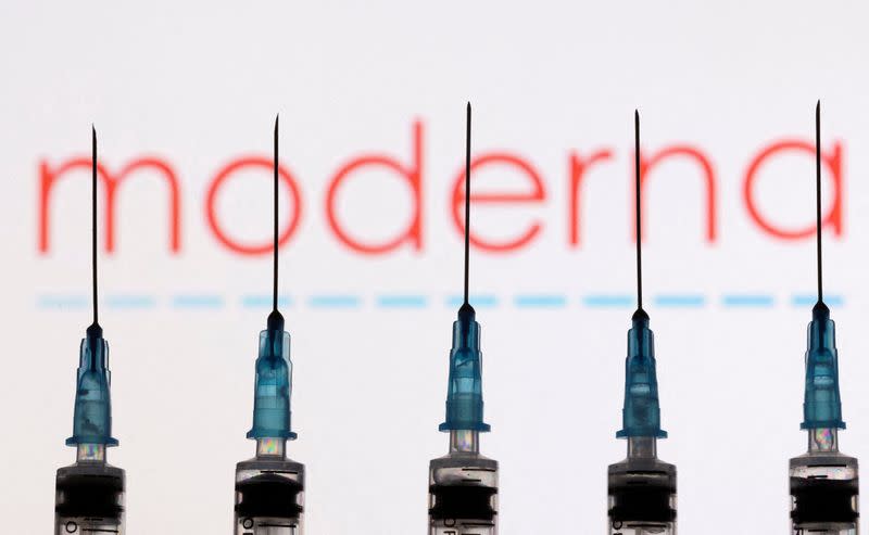 FILE PHOTO: Syringes with needles are seen in front of a displayed Moderna logo in this illustration taken