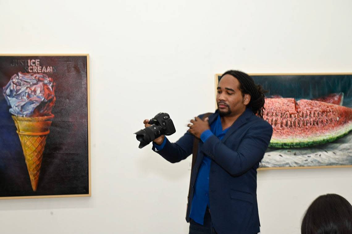 Jamaican artist Michael Elliott in front of his pieces “Sundae Morning” and “Seeds of the Tide (Clotilda)” at Green Space Miami. His artwork deals with the legacy of slavery and racism.