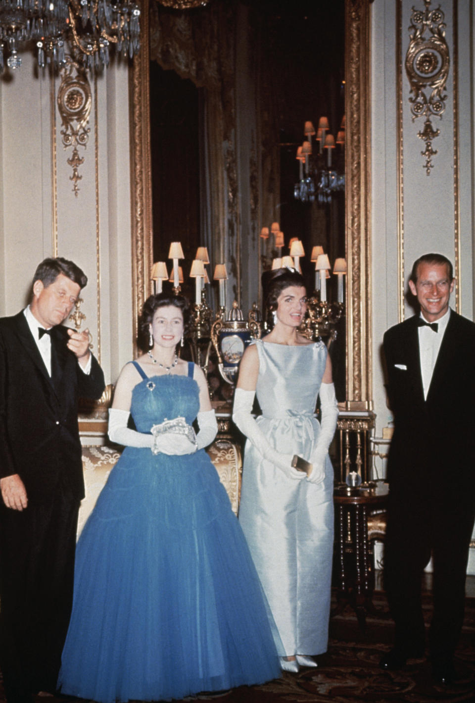 The Kennedys attend an event at Buckingham Palace with Queen Elizabeth II and Prince Philip.