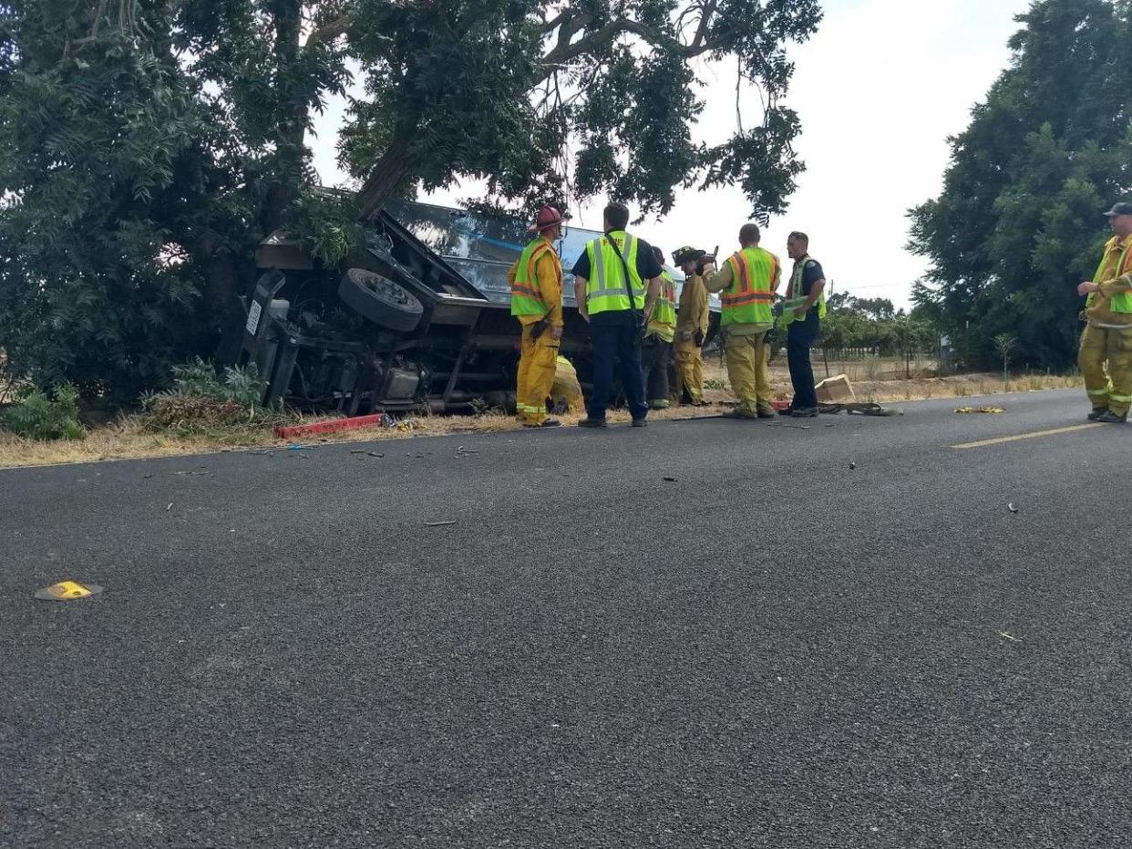 Firefighters survey an overturned Amazon truck involved in a crash on East Harney Lane and Lower Sacramento Road, Lodi.