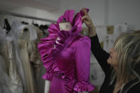 British designer Elizabeth Emanuel stands beside a replica of an evening gown she designed for the then Lady Diana Spencer to wear at a Buckingham Palace party a few days before her marriage to Prince Charles in 1981, in London, Friday, Nov. 18, 2022. Emanuel recreated the dress for her own archive and to show another side of Diana, who Emanuel believes has been misrepresented by "The Crown," the popular Netflix series that has brought the story of the princess and her ill-fated marriage to a new generation. (AP Photo/Kin Cheung)