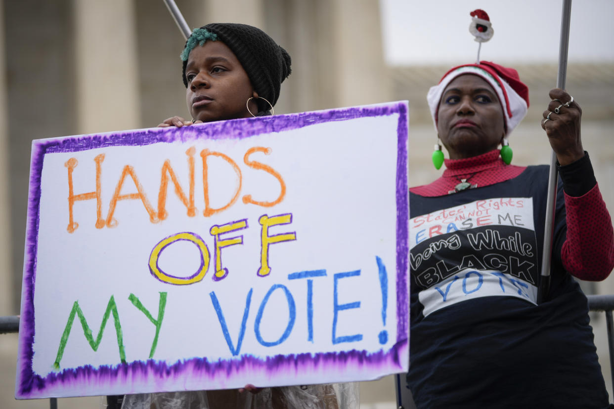 Voting rights activists rally outside the Supreme Court during oral arguments in the Moore v. Harper case. 