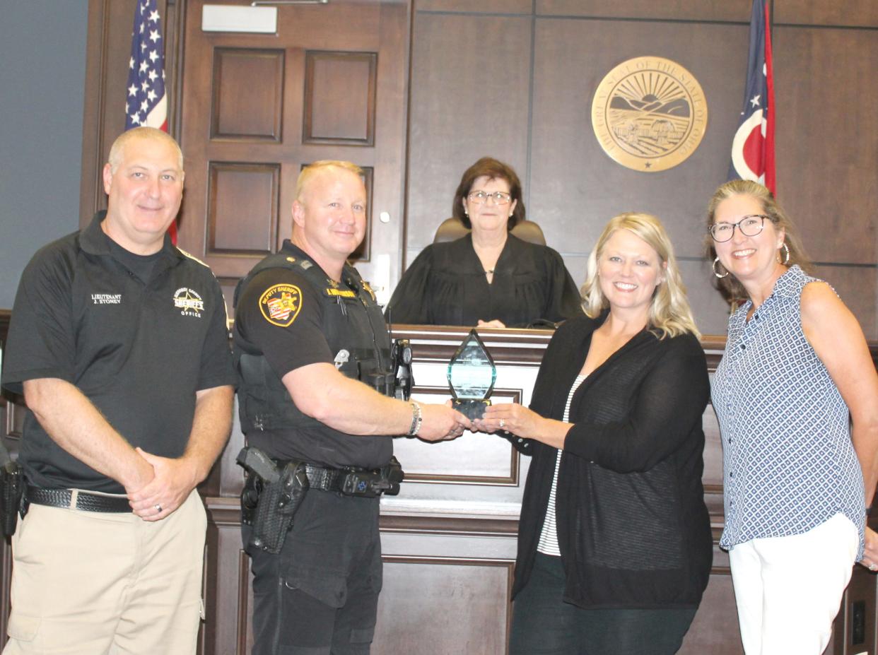 Lieutenant Jim Stoney, Major Jeremy S. Wilkinson, Magistrate Teresa Liston, SSA Director Tanya Hitchens, and Superintendent Kellie Brown, from left, with the award presented to the Guernsey County Board of Developmental Disabilities from the National Association for the Dually Diagnosed.