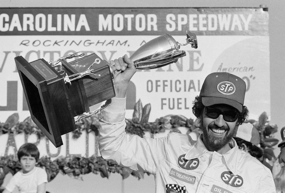 FILE - Richard Petty, of Randleman, N.C., holds up the trophy after winning the Carolina 500 stock car race at the North Carolina Motor speedway, Feb. 29, 1976, in Rockingham, N.C. Considered NASCAR's greatest driver, Petty said the family following through on his grandson Adam's dream with be their lasting legacy. (AP Photo/File)