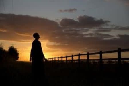 Sister Rachel Denton views the sunset from a vantage point near St Cuthbert's Hermitage in Lincolnshire, north east Britain September 25, 2015. REUTERS/Neil HallPICTURE