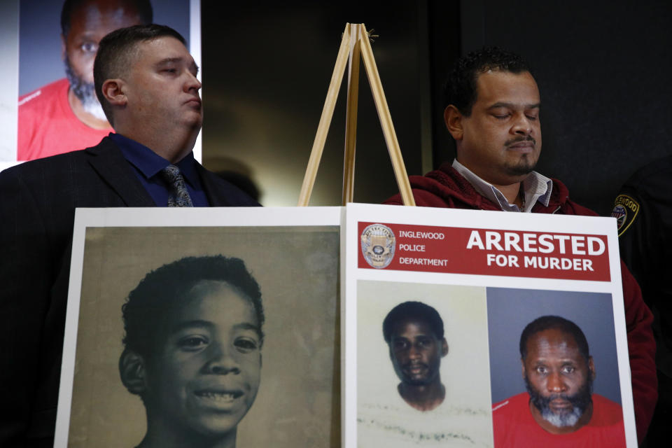 Hubert Tillett, right, brother of William Tillett, stands behind a display showing his brother, bottom left, during a news conference Wednesday, Feb. 20, 2019, in Inglewood, Calif. Authorities say a 50-year-old man is in custody in connection with the kidnapping and killing of then 11-year-old William Tillett in Southern California nearly three decades ago. (AP Photo/Jae C. Hong)