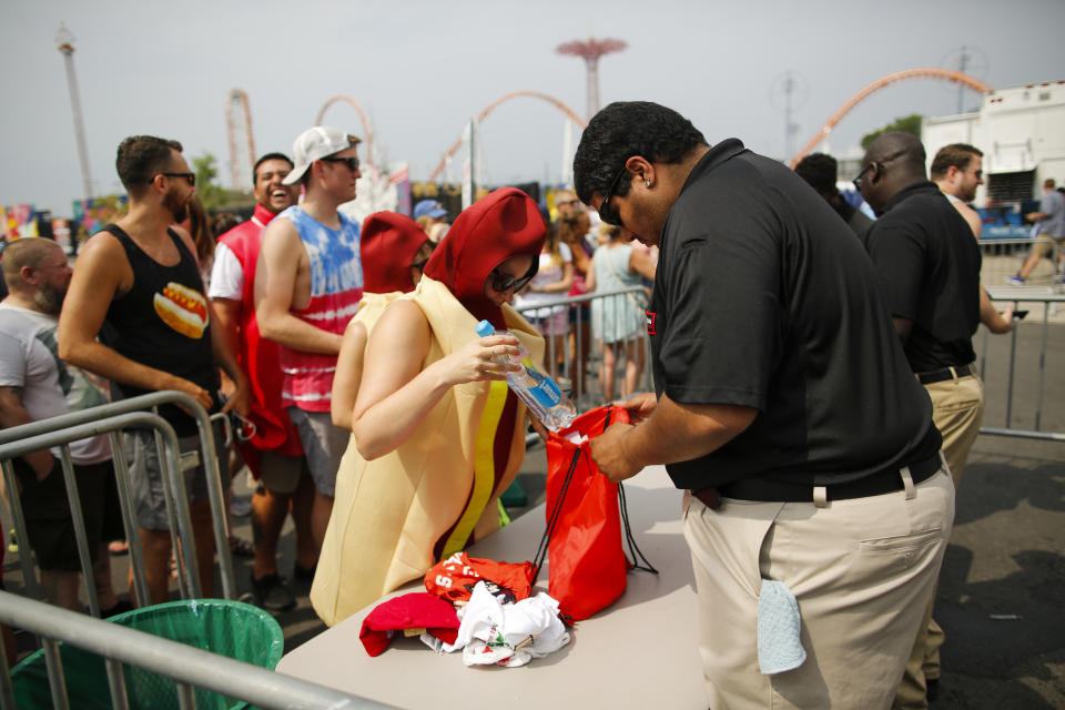 <p>A woman dressed as a hotdog is checked as she attends the Annual Nathan’s Hot Dog Eating Contest on July 4, 2018 in the Coney Island neighborhood of the Brooklyn borough of New York City. In 2017 winner Joey Chestnut set a Coney Island record eating 72 hot dogs. (Photo: Eduardo Munoz Alvarez/Getty Images) </p>