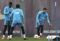 FC Barcelona's Lionel Messi, right, kicks the ball during a training session at the Sports Center FC Barcelona Joan Gamper in Sant Joan Despi, Spain, Friday, May 24, 2019. FC Barcelona will play against Valencia in the Spanish Copa del Rey soccer match final on Saturday. (AP Photo/Manu Fernandez)