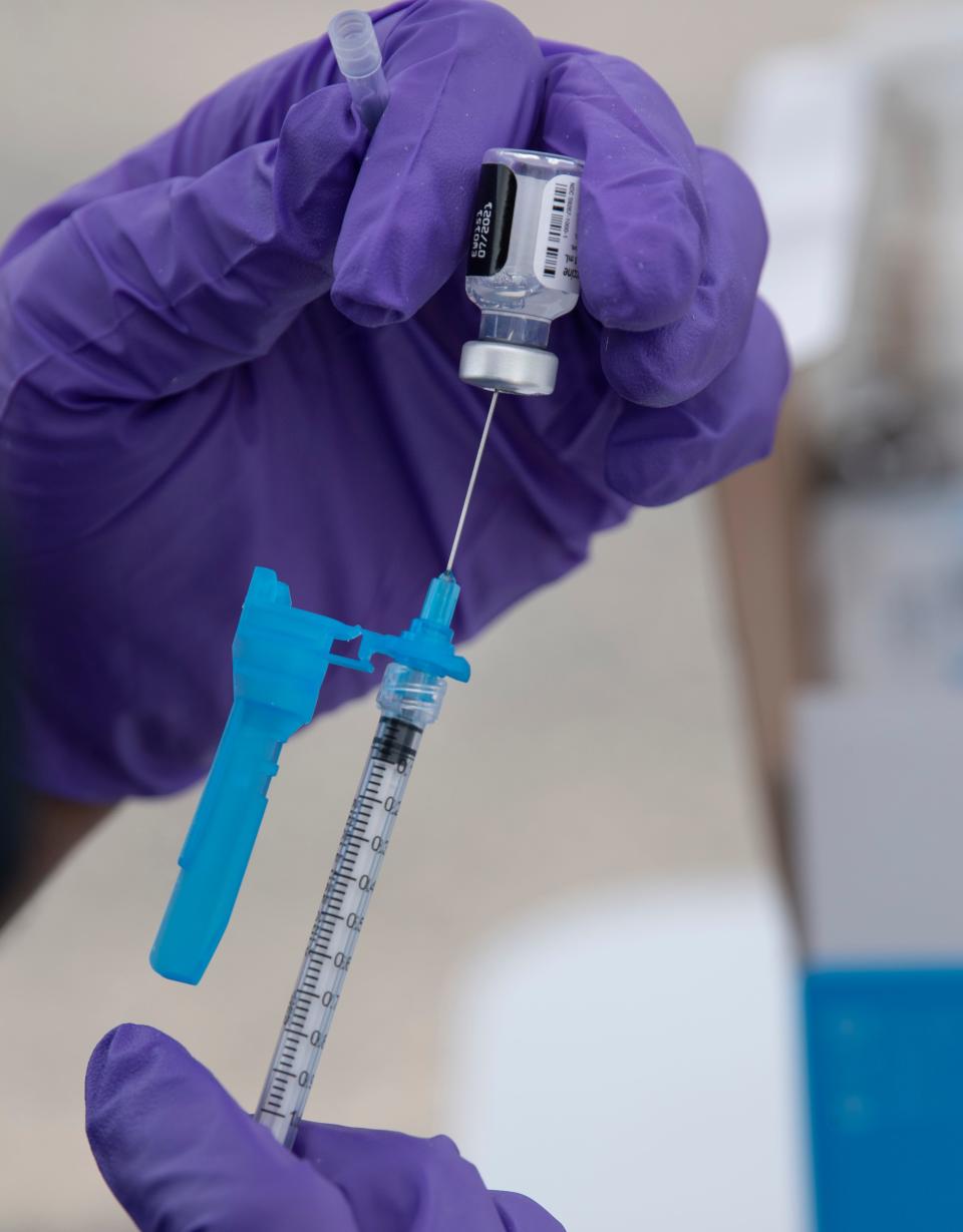 Nikesh Patel of Adhere Rx prepares a COVID-19 vaccine at the First Baptist Church Thursday, April 22, 2021 in Portland, Tenn. The church partnered with Adhere Rx to help the vaccination efforts in the rural area. 