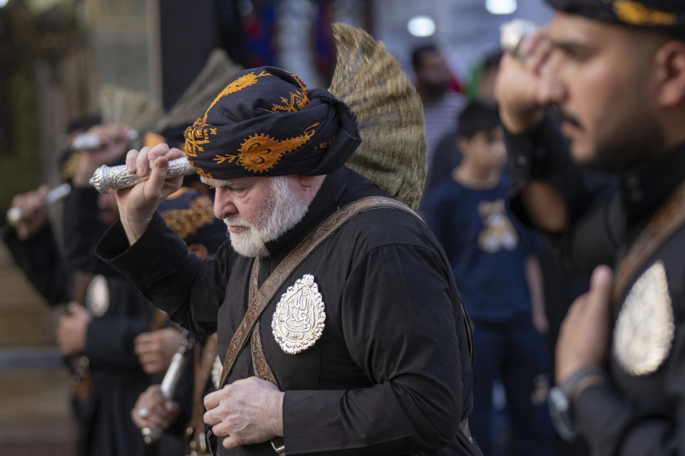 Shiite faithful pilgrims beat themselves with chains as a sign of grief for Imam Hussein, on the 9th day of Muharram, outside the golden-domed shrine of Imam Moussa al-Kadhim in Baghdad, Iraq, Friday, July 28, 2023. During Muharram, Islam's second holiest month, Shiites mark the death of Hussein, the grandson of the Prophet Muhammad, at the Battle of Karbala in present-day Iraq in the 7th century. (AP Photo/Hadi Mizban)