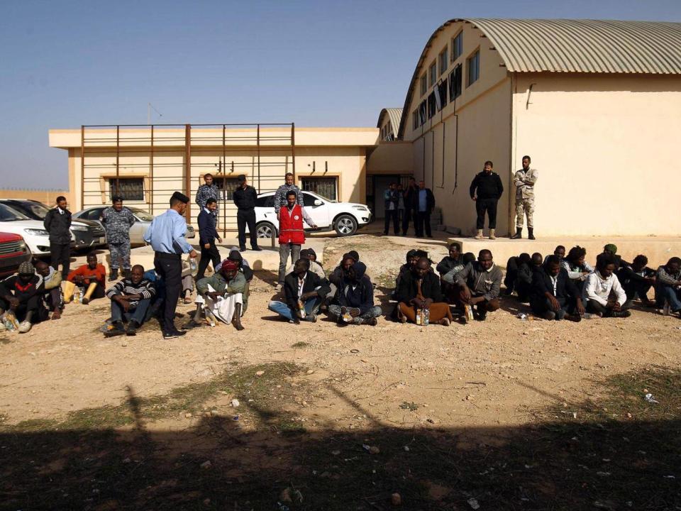 Sub-Saharan migrants sit at the Qanfouda detention centre, in the southern outskitrs of Benghazi (Getty)