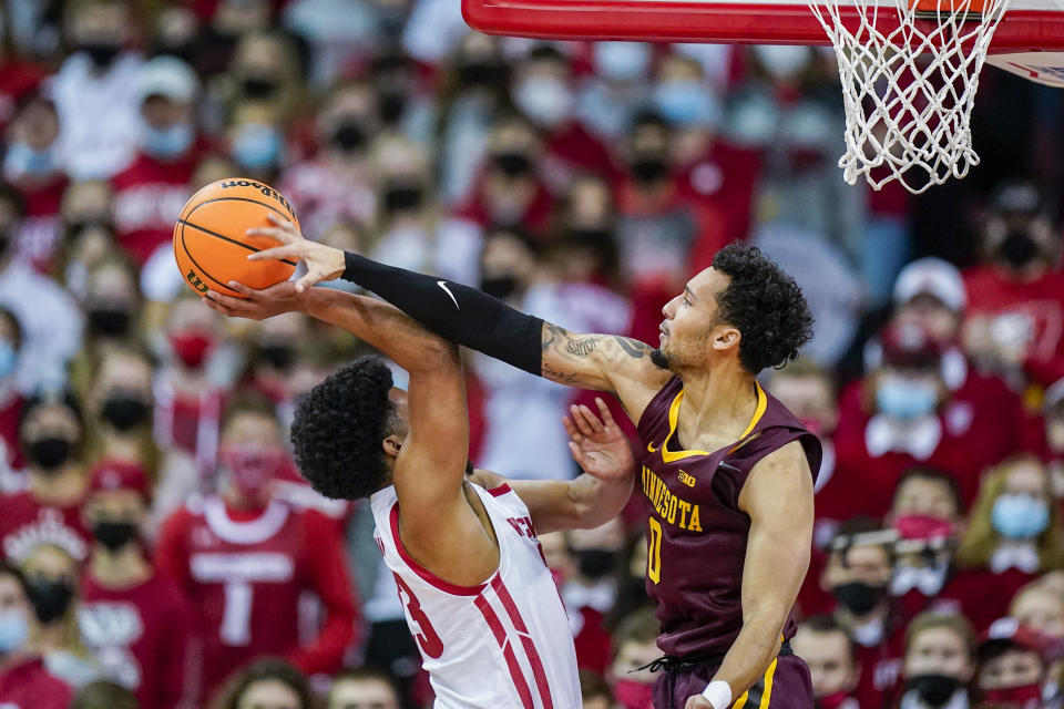 Minnesota's Payton Willis (0) blocks a shot by Wisconsin's Chucky Hepburn (23) during the first half of an NCAA college basketball game Sunday, Jan. 30, 2022, in Madison, Wis. (AP Photo/Andy Manis)