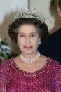 <p> The Queen owned a <em>lot</em> of pearl necklaces, but this three-strand choker with diamond embellishment is a standout—seen here in 1983. </p>