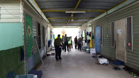 Authorities inside the Manus Island refugee camp in Papua New Guinea walk around the camp serving deportation notices to detainees, February 9, 2017. Behrouz Boochani/Handout via REUTERS