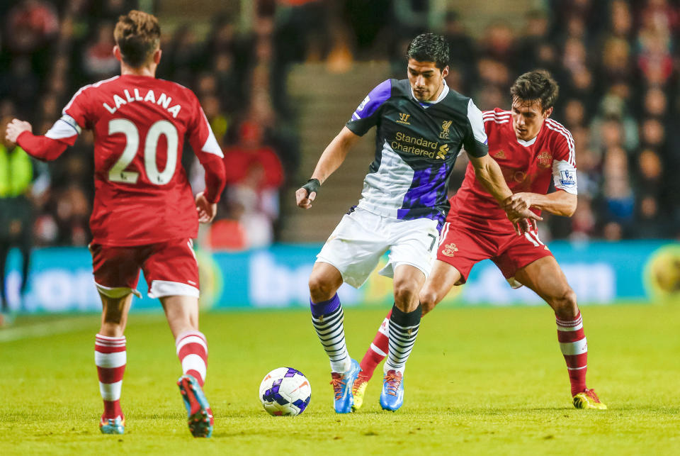 Southampton's Jack Cork, right, tackles Liverpool's Luis Suarez, centre, during their English Premier League match, at St Mary's, Southampton, England, Saturday March 1, 2014. (AP Photo/PA, Chris Ison) UNITED KINGDOM OUT