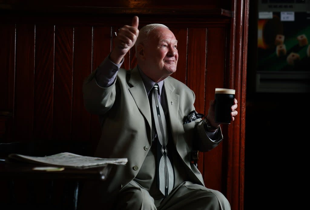 Peter Roche, a regular for 55 years at Mulligans pub in Dublin’s city centre, in conversation while having a pint (Brian Lawless/PA) (PA Wire)