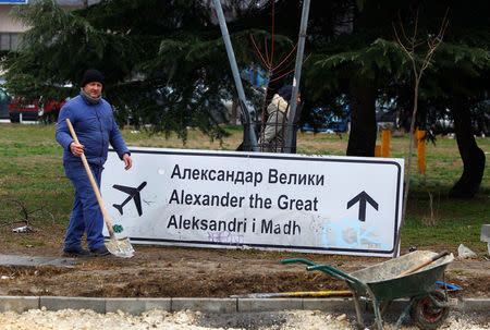 A worker passes a sign for Alexander the Great Airport which was removed due to road construction in Skopje, Macedonia February 19, 2018. REUTERS/Ognen Teofilovski