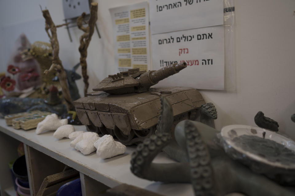 A sculpture depicting a tank is displayed at the pottery workshop in Kibbutz Mishmar HaEmek, Northern Israel, Sunday, Feb. 4, 2024. (AP Photo/Leo Correa)