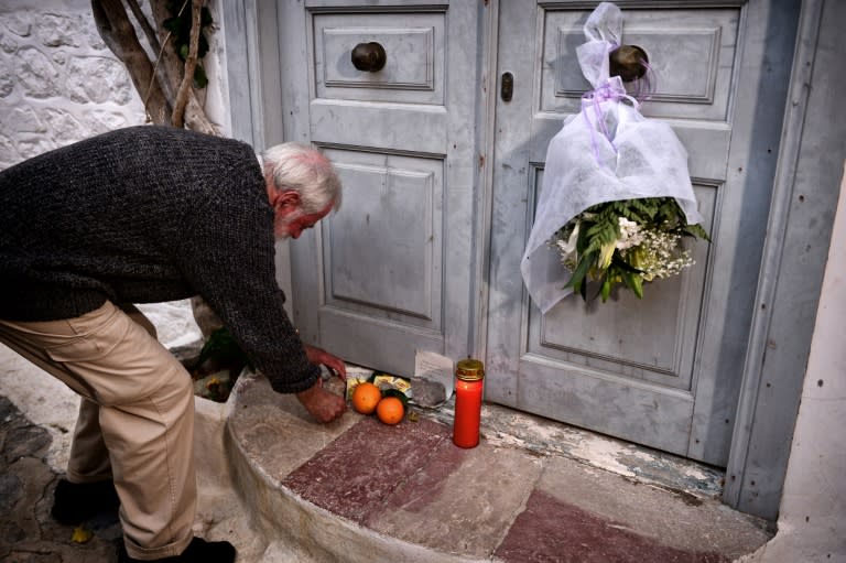 British writer and resident Roger Green leaves a stone outside the summer house of late Canadian singer-songwritter and poet Leonard Cohen, on the Greek island of Hydra, on November 11, 2016