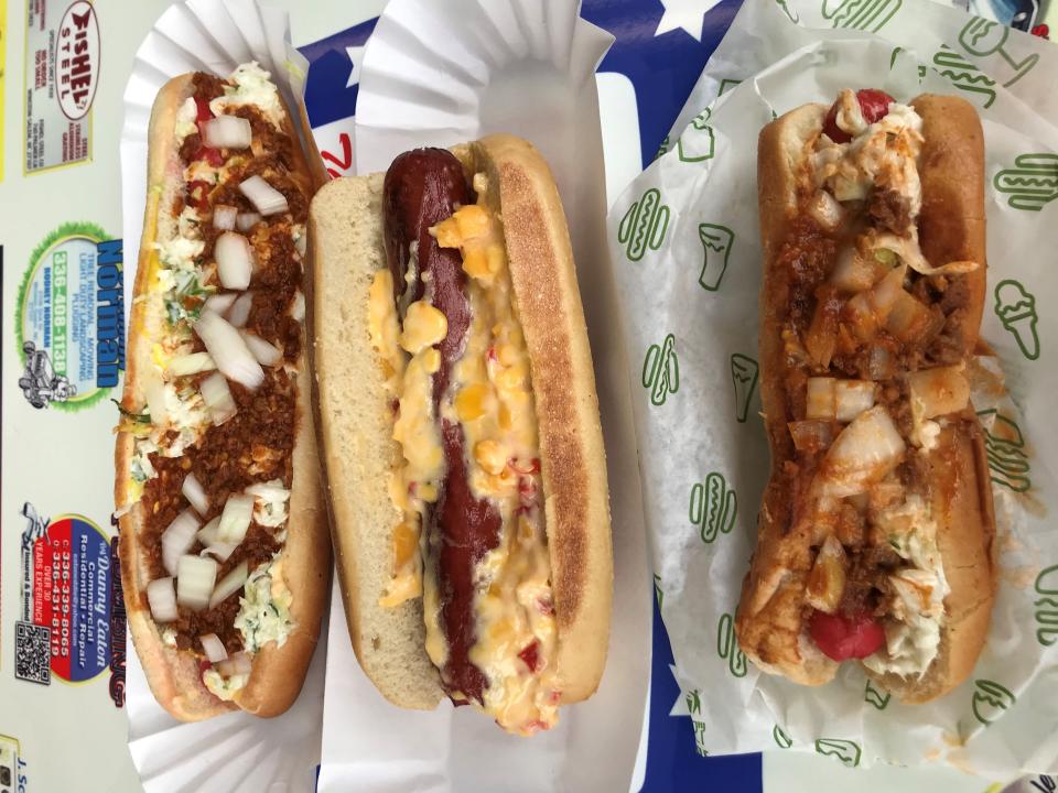 The three hot dog options at Kermit’s are (left to right): foot-long pork and beef dog (with “all the way” toppings), quarter-pound all-beef super frank (with pimento cheese) and regular-sized pork and beef dog (with onions, chili and slaw).