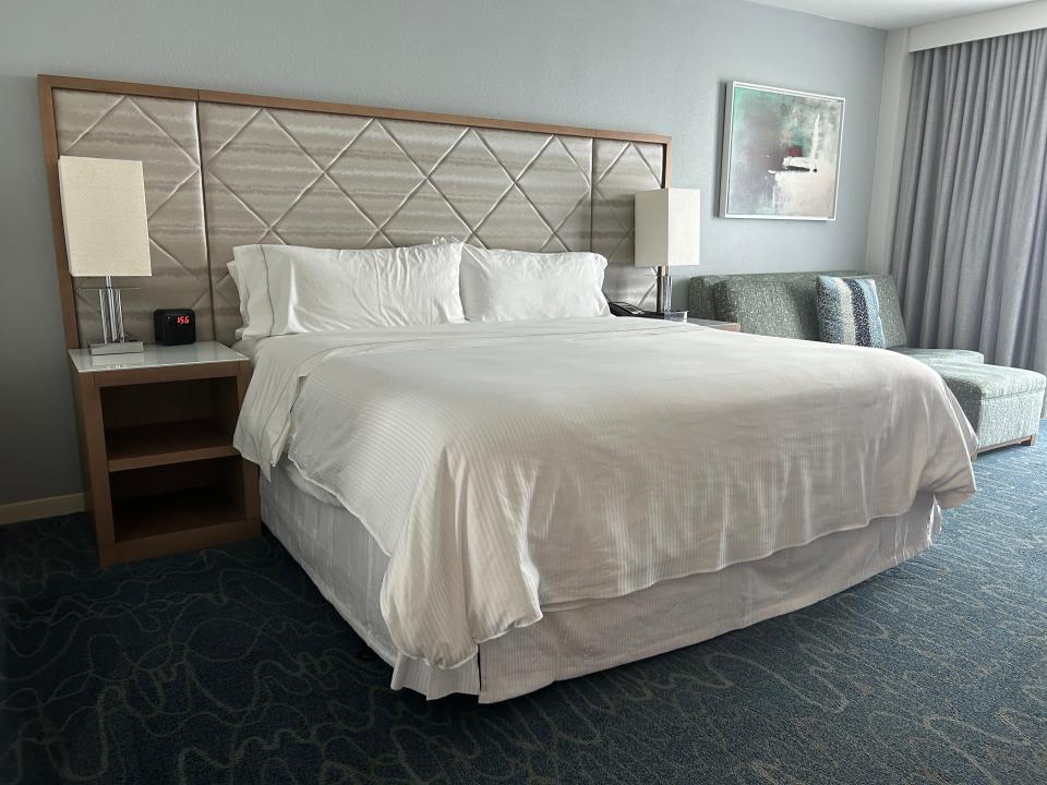 room with a queen bed inside disney's swan hotel at disney world