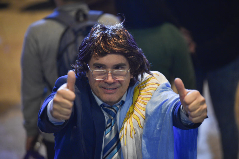 A supporter dressed as Argentine President Javier Milei poses for a photo at a promotional event for Milei's new book in Buenos Aires, Argentina, Wednesday, May 22, 2024. (AP Photo/Gustavo Garello)