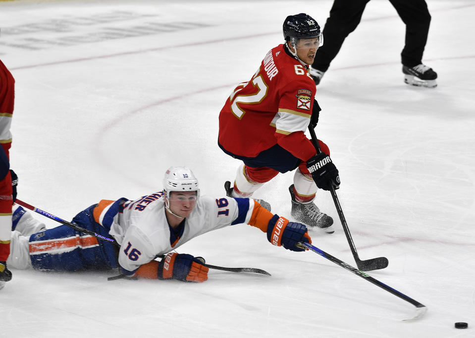 Florida Panthers defenseman Brandon Montour (62) skates to the puck against New York Islanders right wing Julien Gauthier (16) during the second period of an NHL hockey game, Saturday, Dec. 2, 2023, in Sunrise, Fla. (AP Photo/Michael Laughlin)