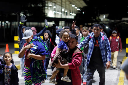 People belonging to a caravan of migrants from Honduras en route to the United States, walk at the border crossing to Mexico in Hidalgo, Mexico, January 18, 2019. REUTERS/Jose Cabezas