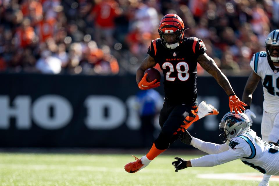 Cincinnati Bengals running back Joe Mixon (28) avoids a tackle by Carolina Panthers cornerback Myles Hartsfield (38) in the first quarter during a Week 9 NFL game, Sunday, Nov. 6, 2022, at Paycor Stadium in Cincinnati. Mandatory Credit: Albert Cesare-The Enquirer