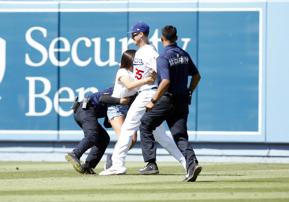 A fan runs on to the field to hug Los Angeles Dodgers right fielder Cody Bellinger (35) during the game against the Colorado Rockies on June 23, 2019, at Dodger Stadium in Los Angeles, CA. (Photo by Adam Davis/Icon Sportswire)